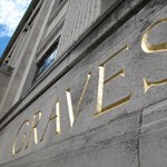 The word Graves carved into the stone fascia of the building.