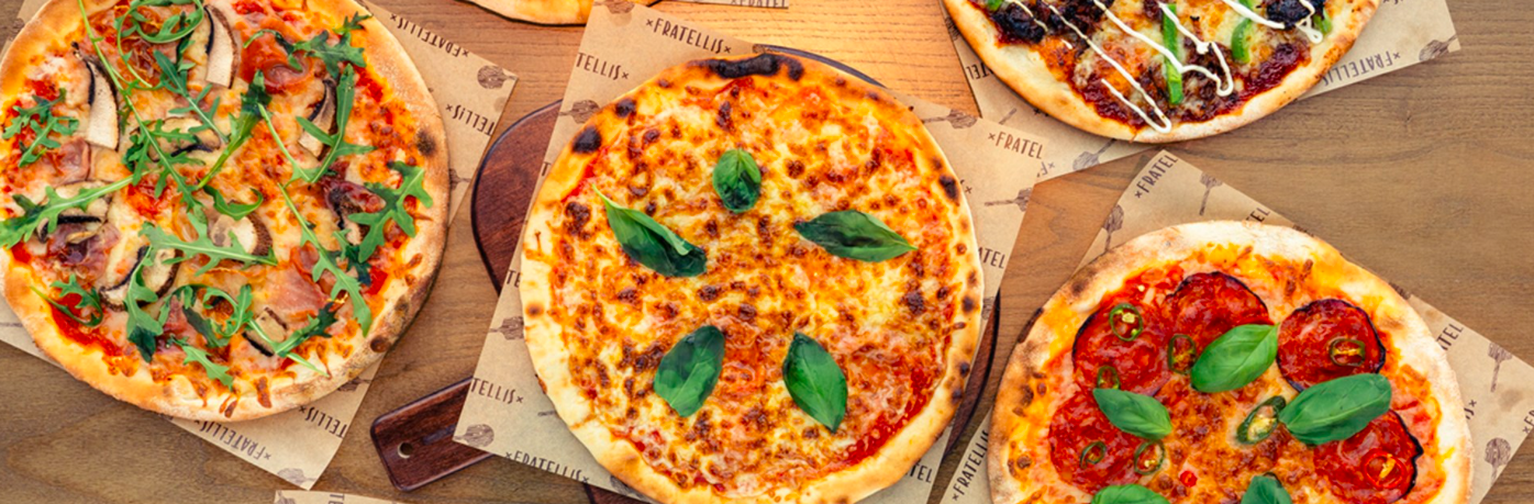 Three pizzas on a table.