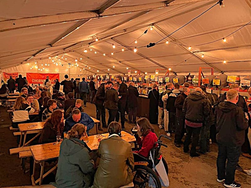 A tent filled with people at the Steel City Beer And Cider Festival.