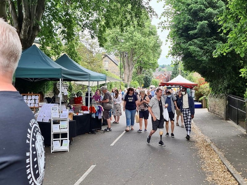 Crowds wander along stalls at the leafy Nether Edge Market