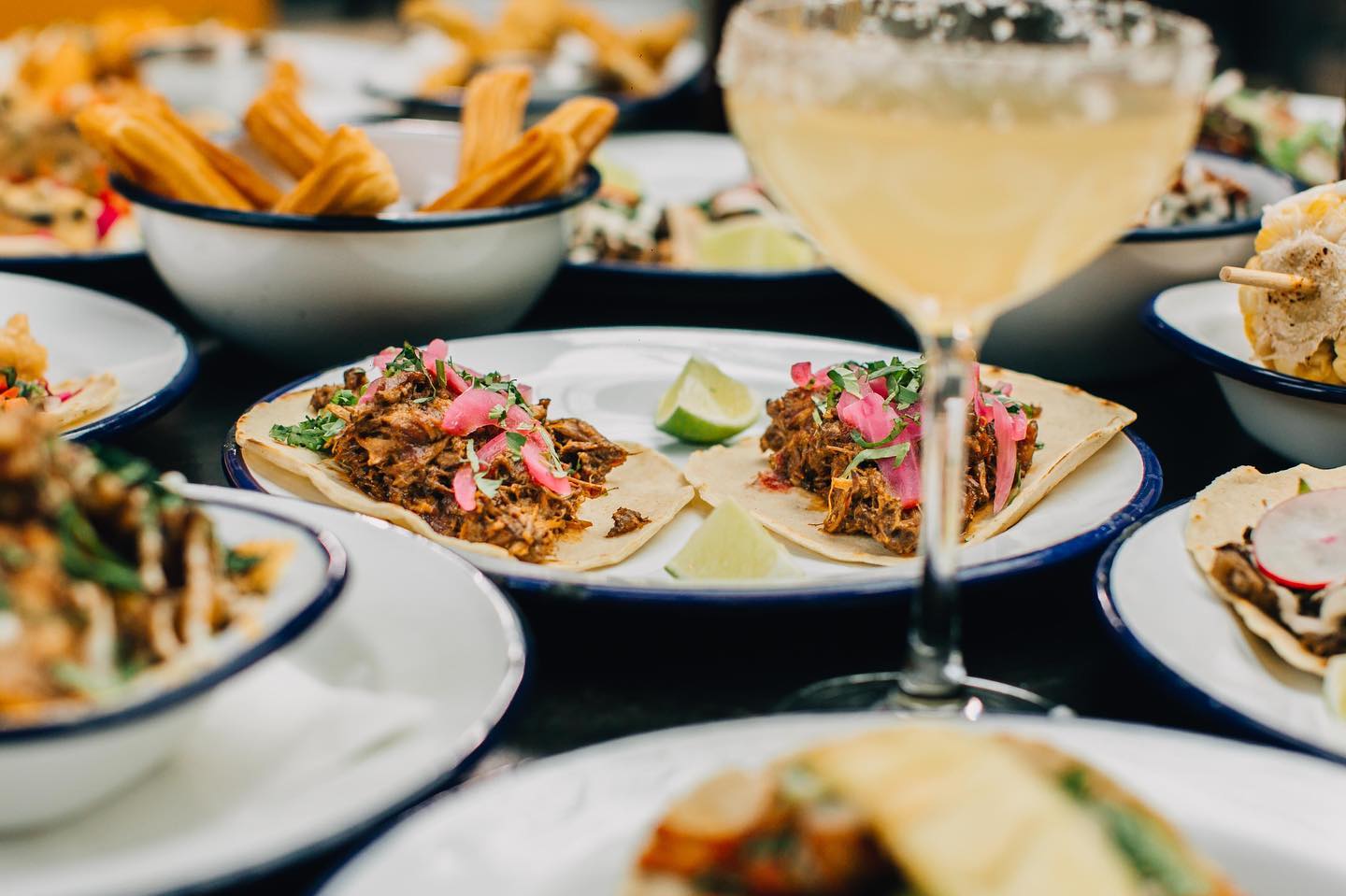 Plates of various different dishes arranged on a table.