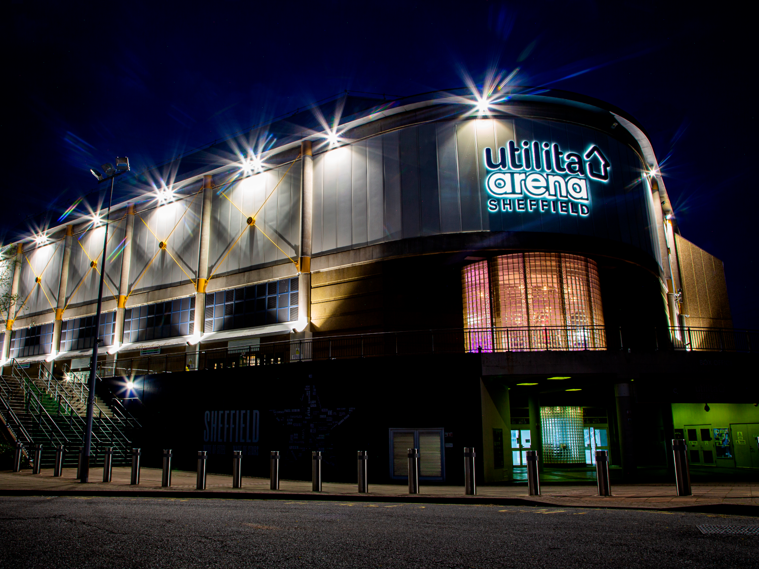 The exterior of ta Arena Sheffield lit up at night.