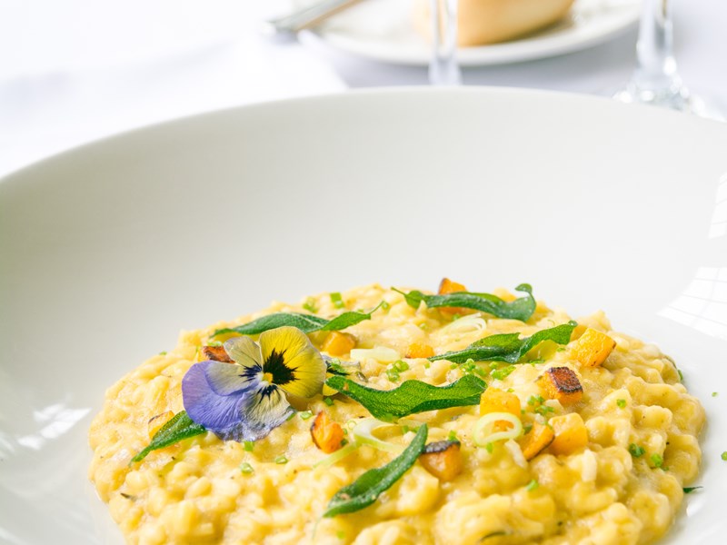 A plate of food and a glass of wine.