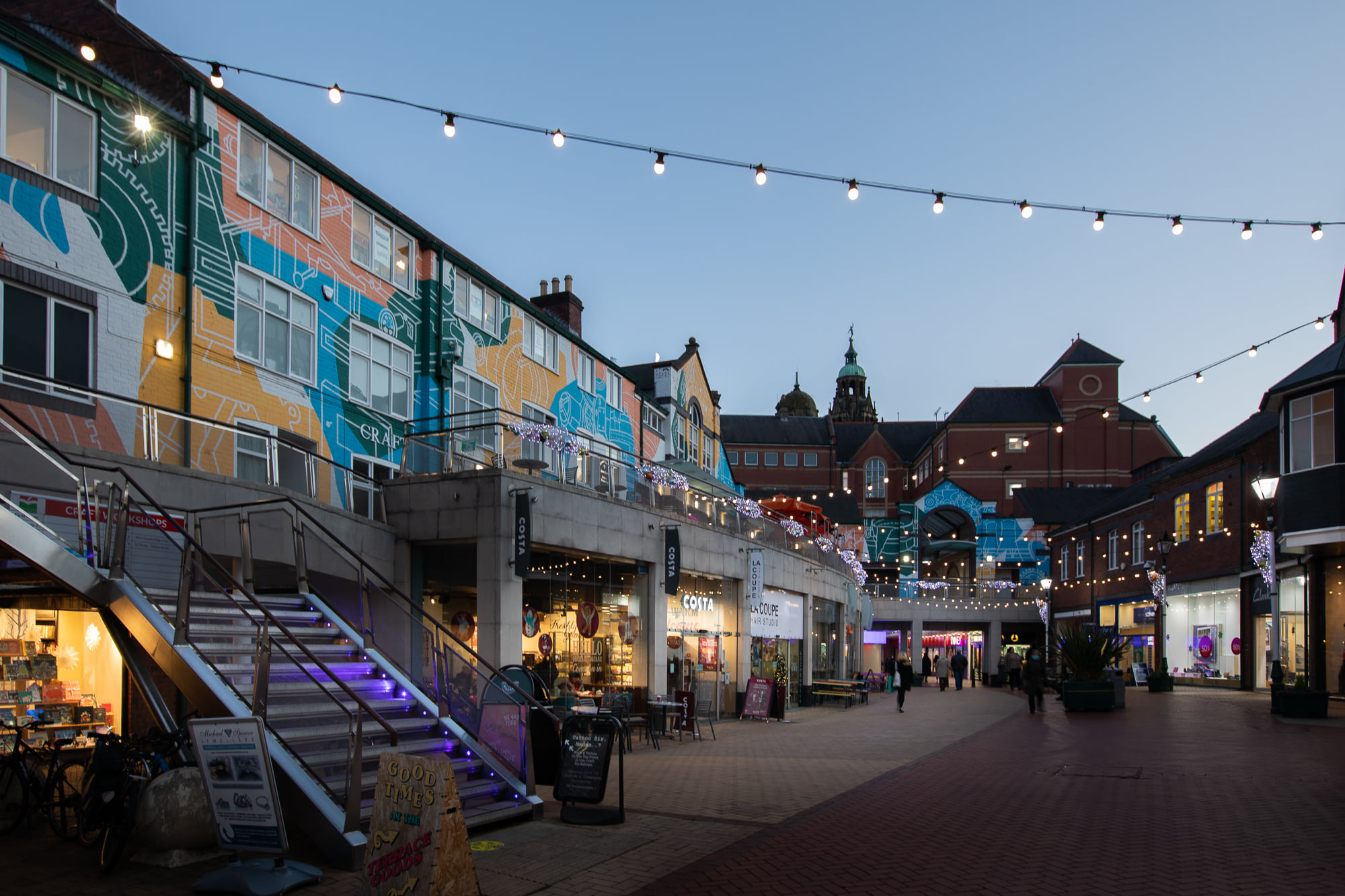 Inside Orchard Square at dusk.