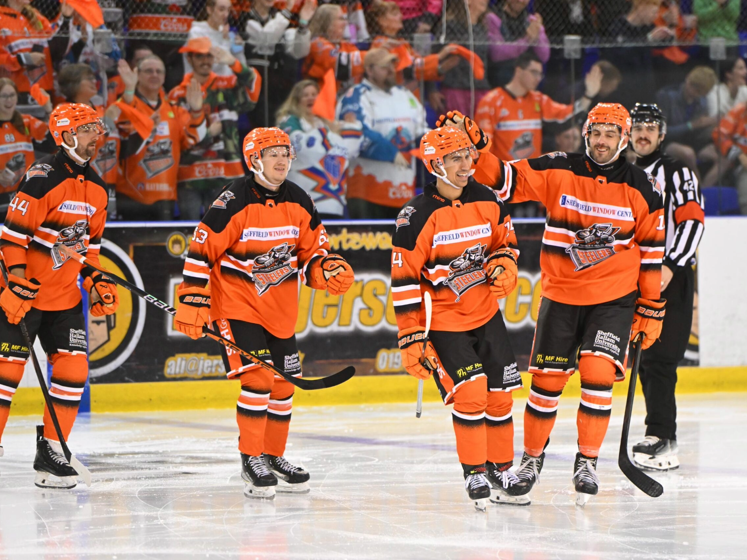 Members of the Sheffield Steelers ice hockey team on the ice at Utilita Arena.