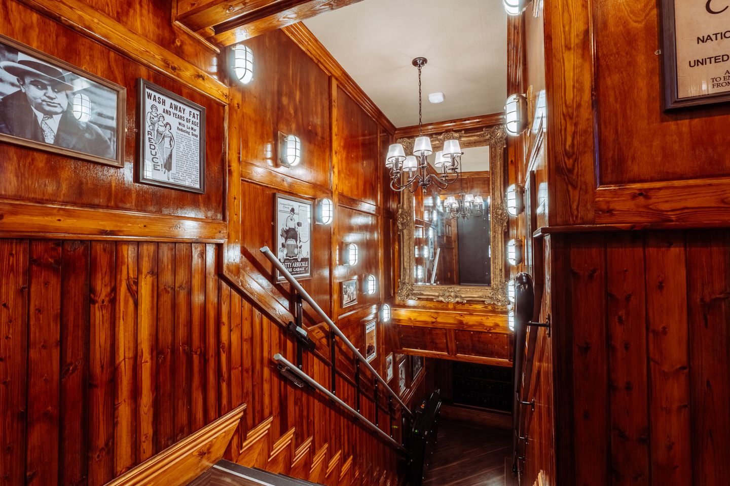 Wood panelled stairs heading down into Capone's Speakeasy.