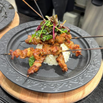 A grilled dish served on skewers.