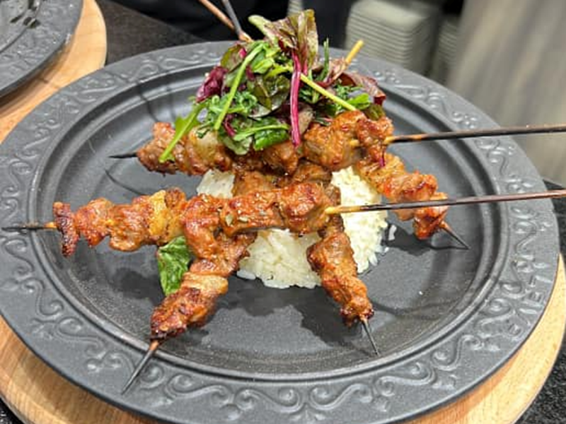 A grilled dish served on skewers.