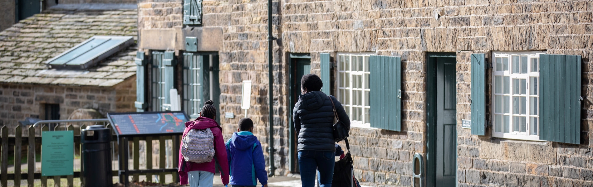 A family looking around the Abbeydale Industrial Hamlet.