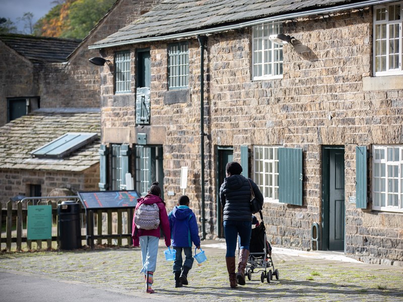 A family looking around the Abbeydale Industrial Hamlet.