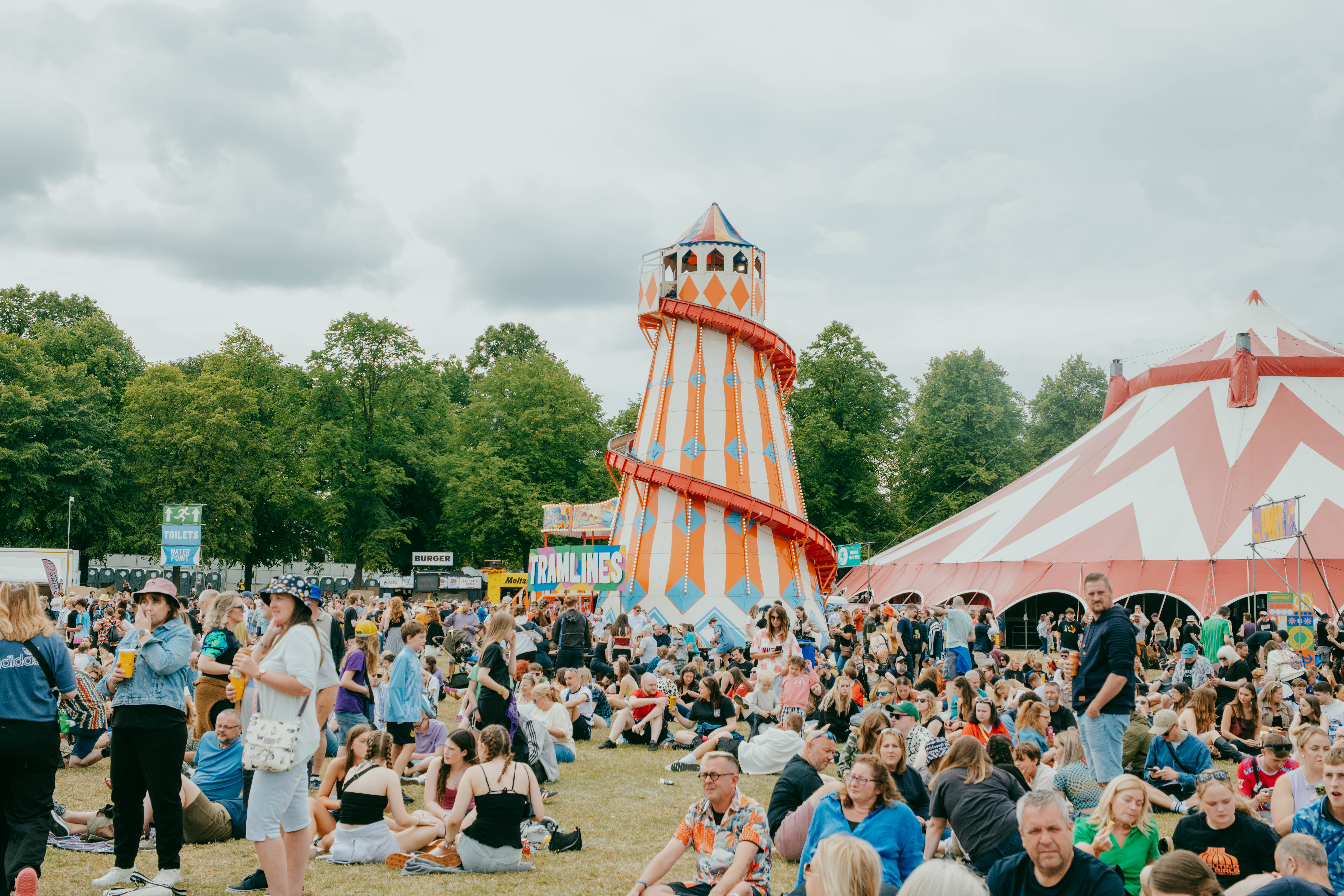 Helter skelter surrounded by a crowd of festival goers 