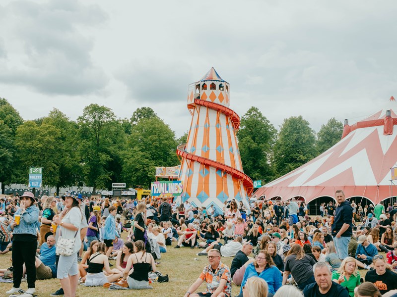 Helter skelter surrounded by a crowd of festival goers