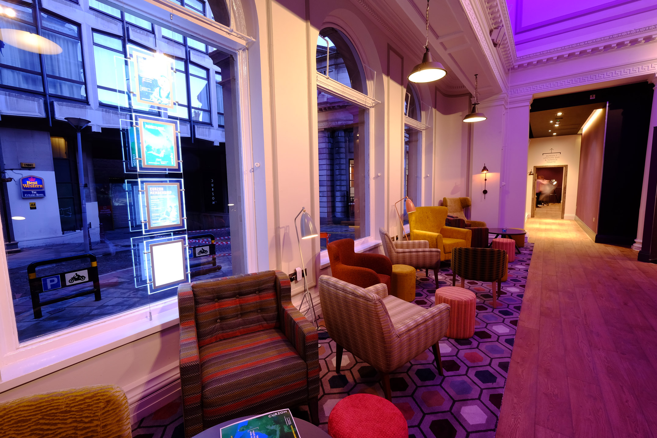 A waiting area at Curzon Sheffield, with armchairs and coffee tables.