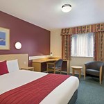 Bedroom featuring a double bed positioned near a window with natural light.