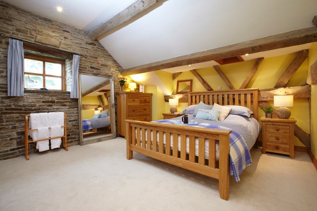 Bedroom at Smallshaw Cottages & Spa featuring a double bed with crisp linens, bedside tables, and soft ambient lighting.