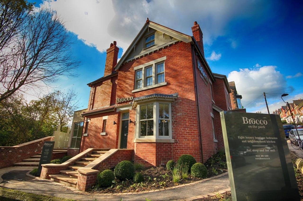 The exterior of Brocco On The Park, a red brick building set in lovely garden.