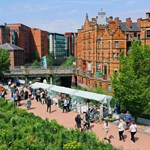 Pollen Market taking place on Sheffield's Grey to Green, on a sunny day with a flock of people walking about