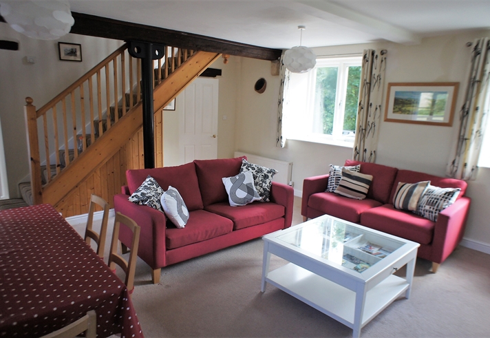 Living room with seating, a coffee table, and décor creating a cozy and welcoming atmosphere.