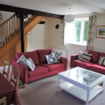 Living room with seating, a coffee table, and décor creating a cozy and welcoming atmosphere.