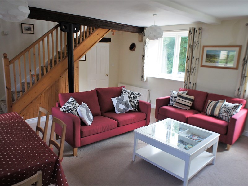 Living room with seating, a coffee table, and décor creating a cozy and welcoming atmosphere.