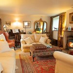 Loadbrook Cottage – living room with soft furnishings and a log burner.