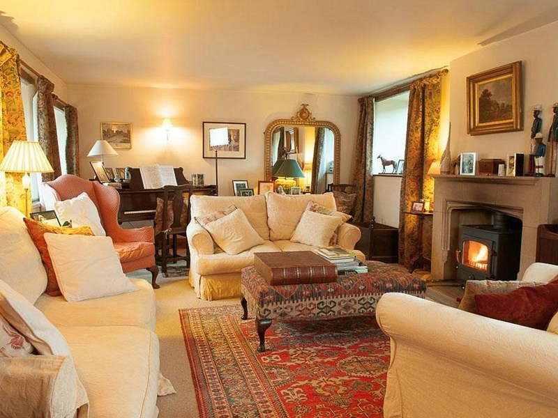 Loadbrook Cottage – living room with soft furnishings and a log burner.