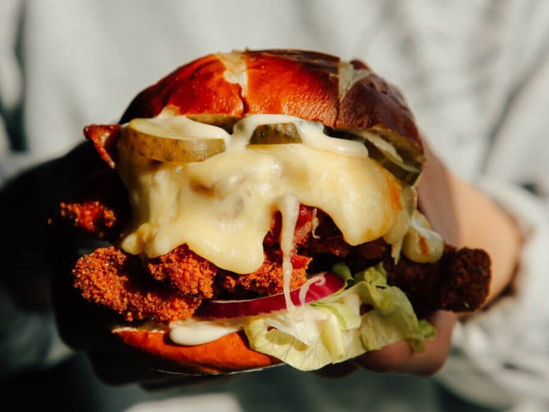 A cheese burger being carried by a member of staff at the Two Thirds Beer Co.