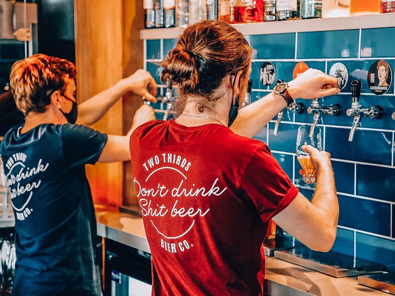 Two members of staff pulling pints at the Two Thirds Beer Co.
