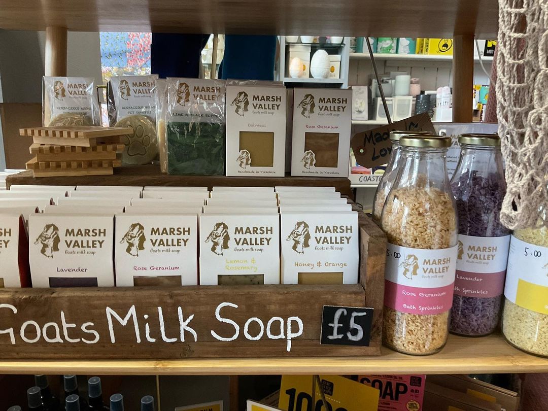 A shelf stacked with goods for sale.