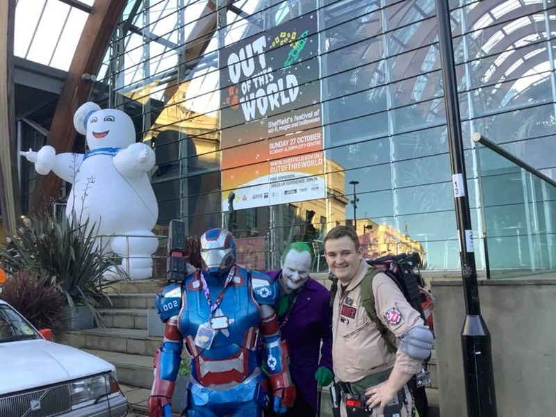 Performers dressed as characters from films, standing outside the Sheffield Winter Garden.