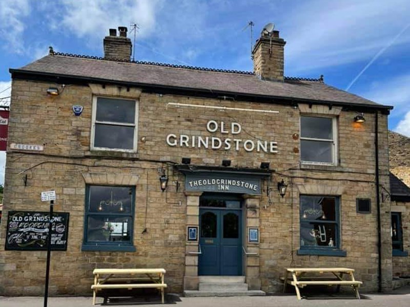 The exterior of The Old Grindstone on a sunny day.