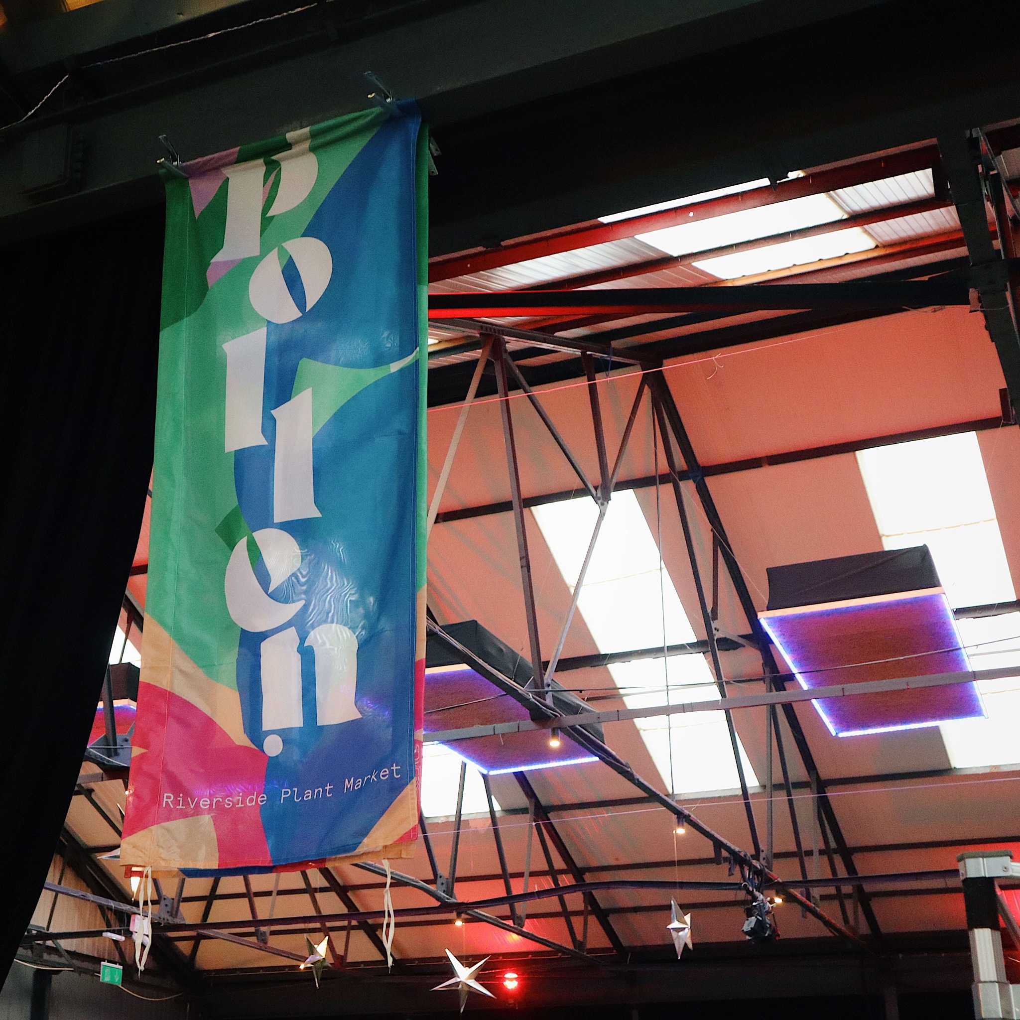 A Pollen Market banner hanging from the roof in Peddler Warehouse.