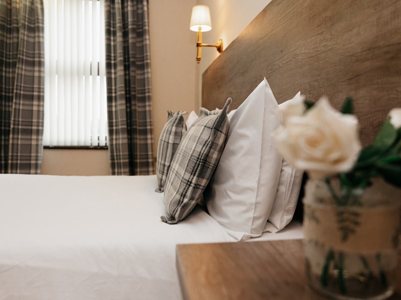 A double bed in a hotel room.