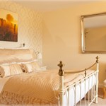 A double bed in a nicely decorated room.