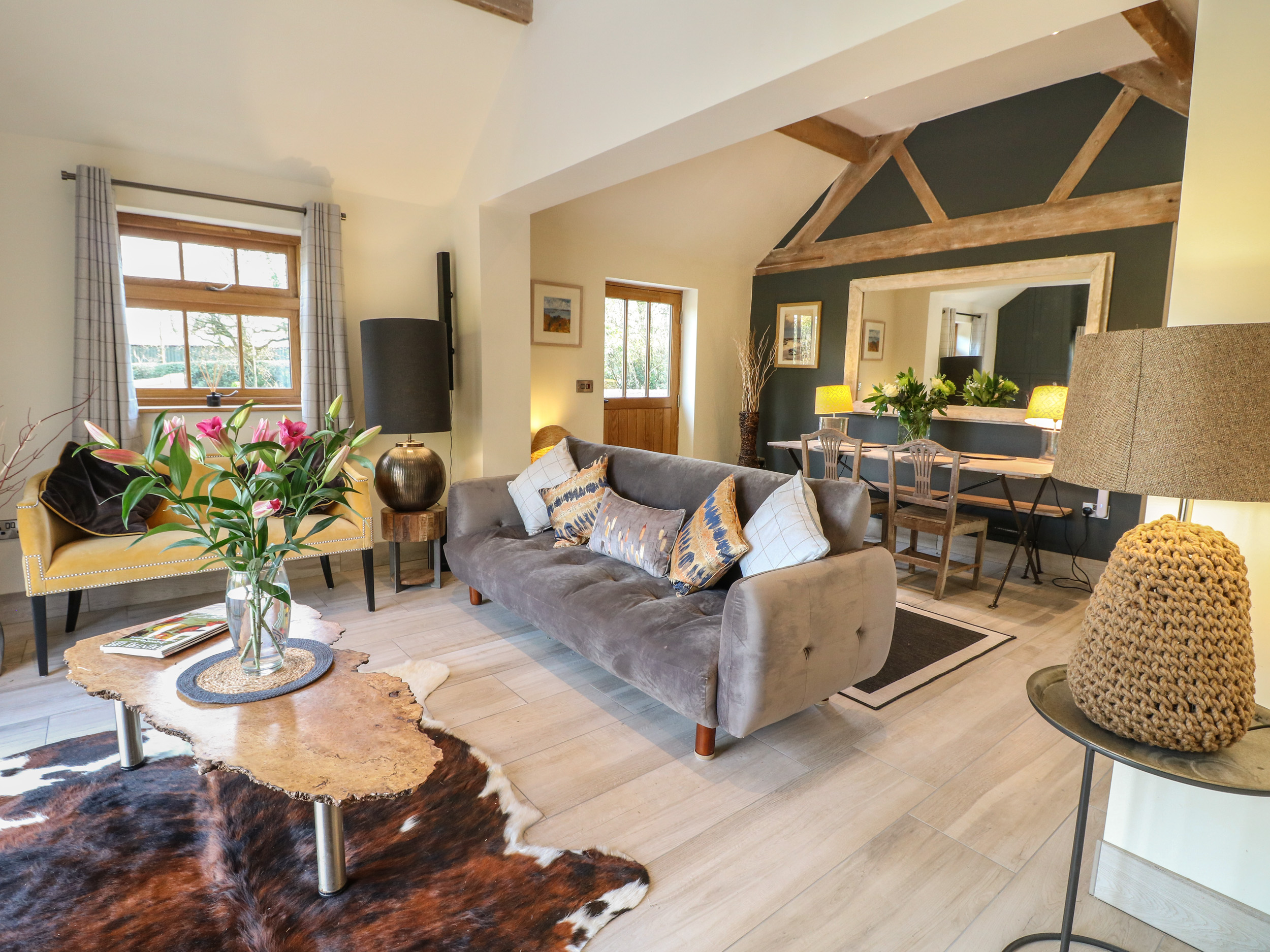Comfortable living room in a Sykes Holiday Cottage with sofa and coffee table.