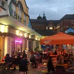 People dining outside at Terrace Goods, in the evening.