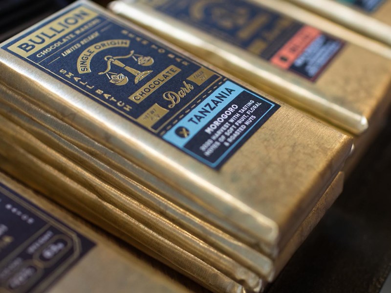 A close-up of bars of Bullion chocolate stacked up on a display.