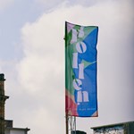 Pollen Market branded flag in front of clock tower