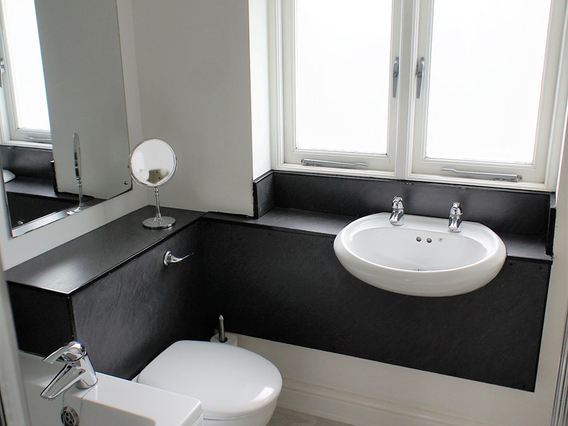 Bathroom with a sink, toilet, and shower or bathtub