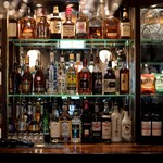 Shelves of spirits and bar snacks behind the bar at The British Oak.