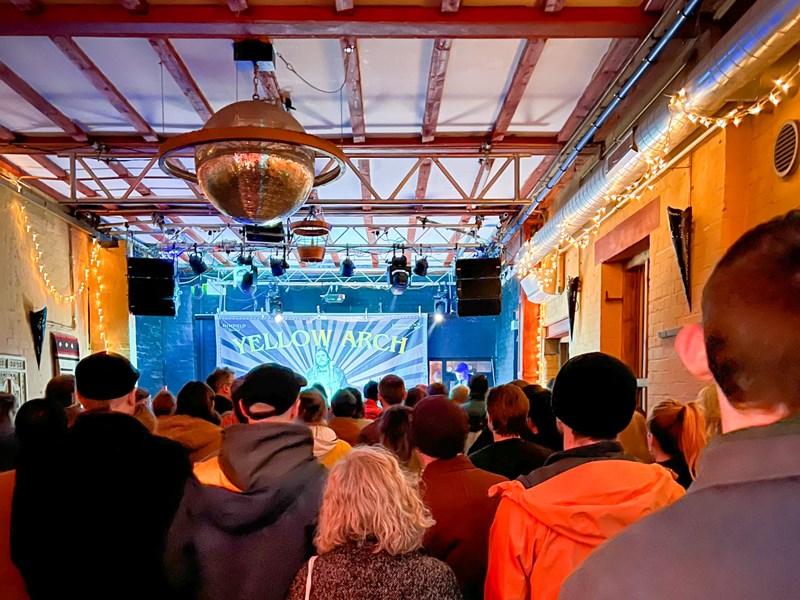 A crowd watches a band performing at Yellow Arch.