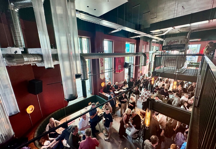 Looking down on lots of people drinking and socialising at Kapital Sheffield beer hall, from the upper floor balcony
