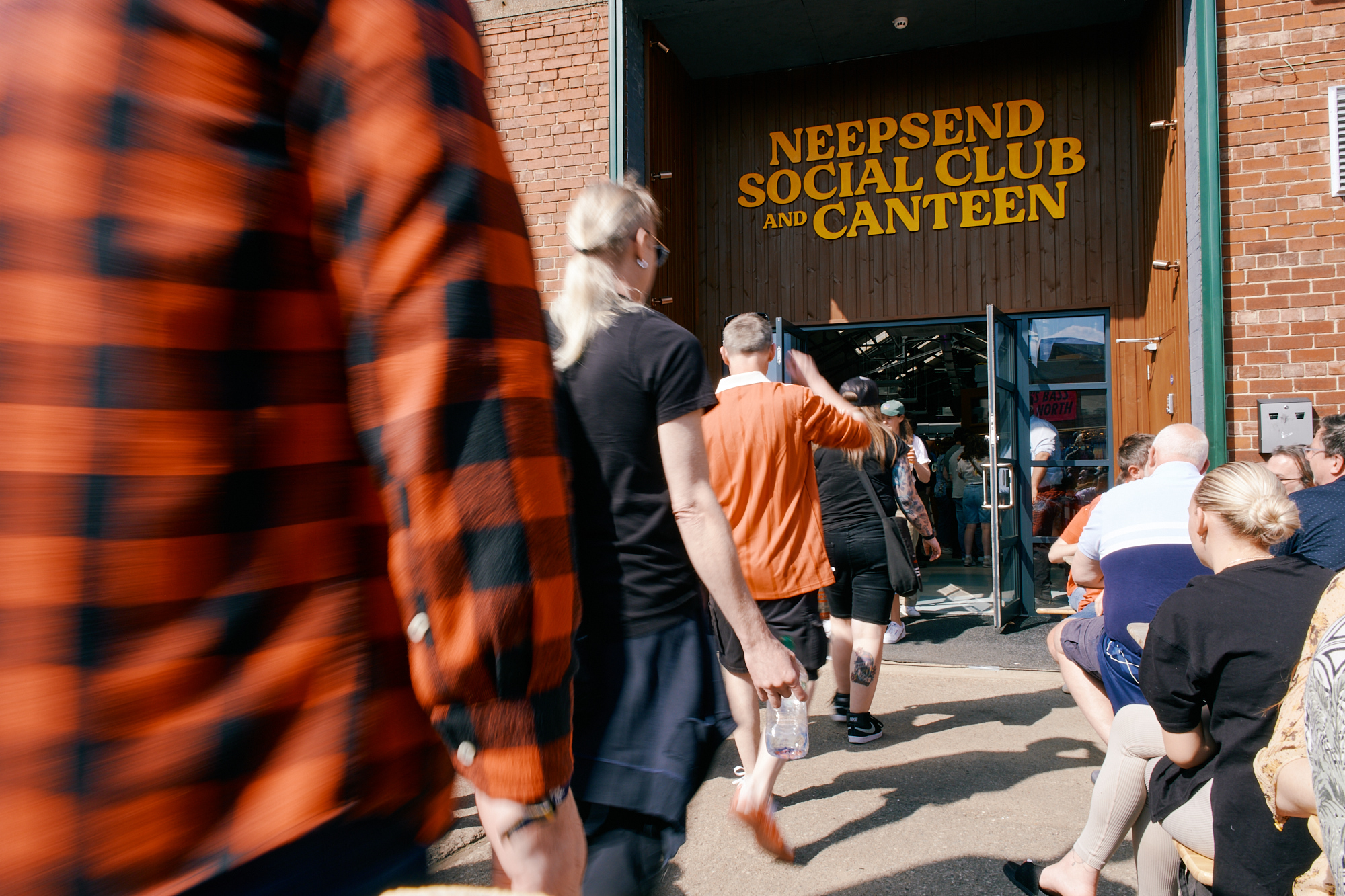 People walking into Neepsend Social Club, with distinct signage above the doorway 