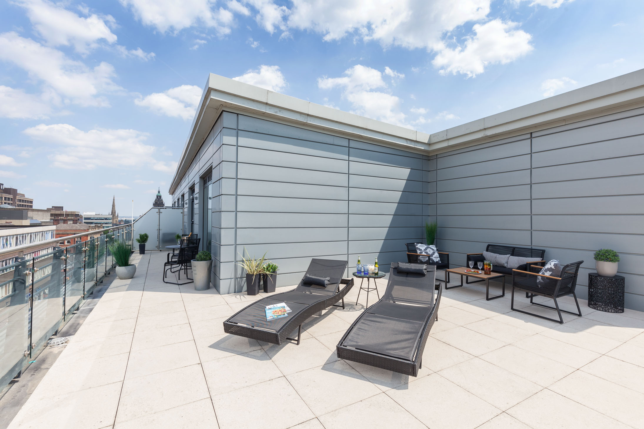 Rooftop patio at K Space @ The Point with outdoor seating and city views.