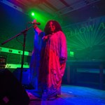 A woman sings live on the stage at Yellow Arch.