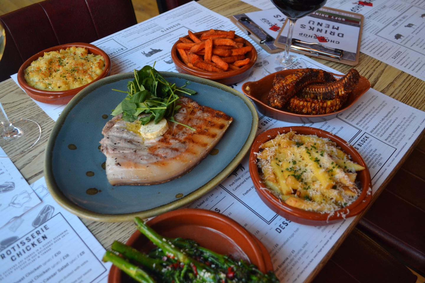 A table set up with meals for 4 people at the Chop Shop Bar & Grill..