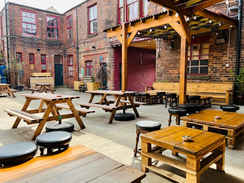 The courtyard at Yellow Arch, with tables and chairs.