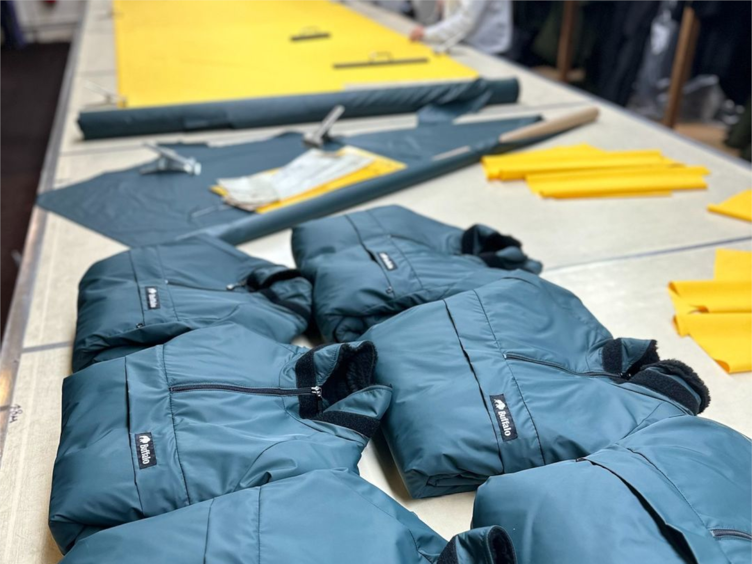 A table with Buffalo Systems clothing laid out.