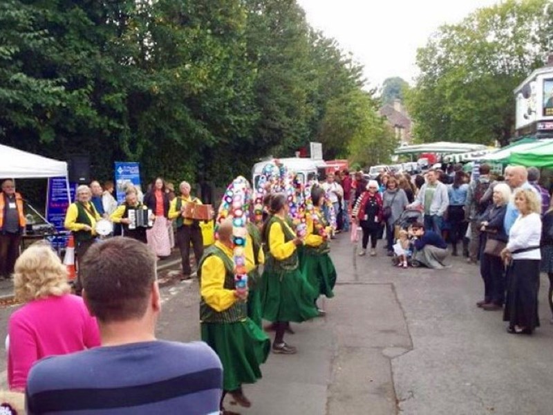 Morris dancers performing in front of crowds  at Nether Edge Market
