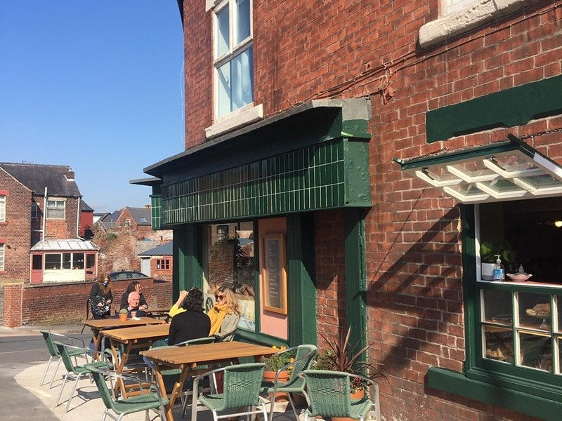 Tables set up outside Kopi & Chai.